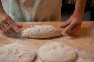 Andrea Colognese of The Village Hearth Bakery and Cafe shaping loaves