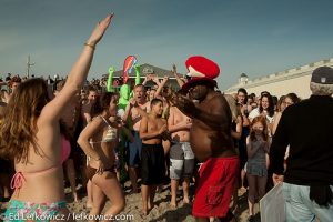 A crowd gathers on the beach for the January 1st Polar Bear plunge in Narragansett, RI