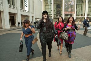 Four well-dressed plus-size women at Fashion Week in New York.