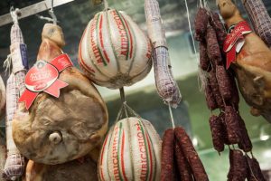 Cheeses and charcuterie hang at Di Palo's market in Little Italy