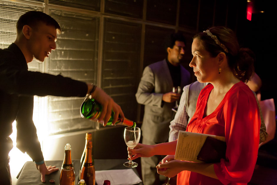 A bar tender pouring a sample of Marquis de la Tour for a woman at a wine tasting