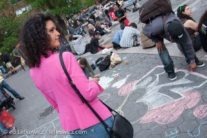 Woman in a pink jacket looking at sidewalk art in Union Square