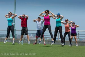 A group of seven people exercising on a New York pier
