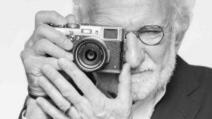 Portrait of photographer Ed Lefkowicz holding a camera