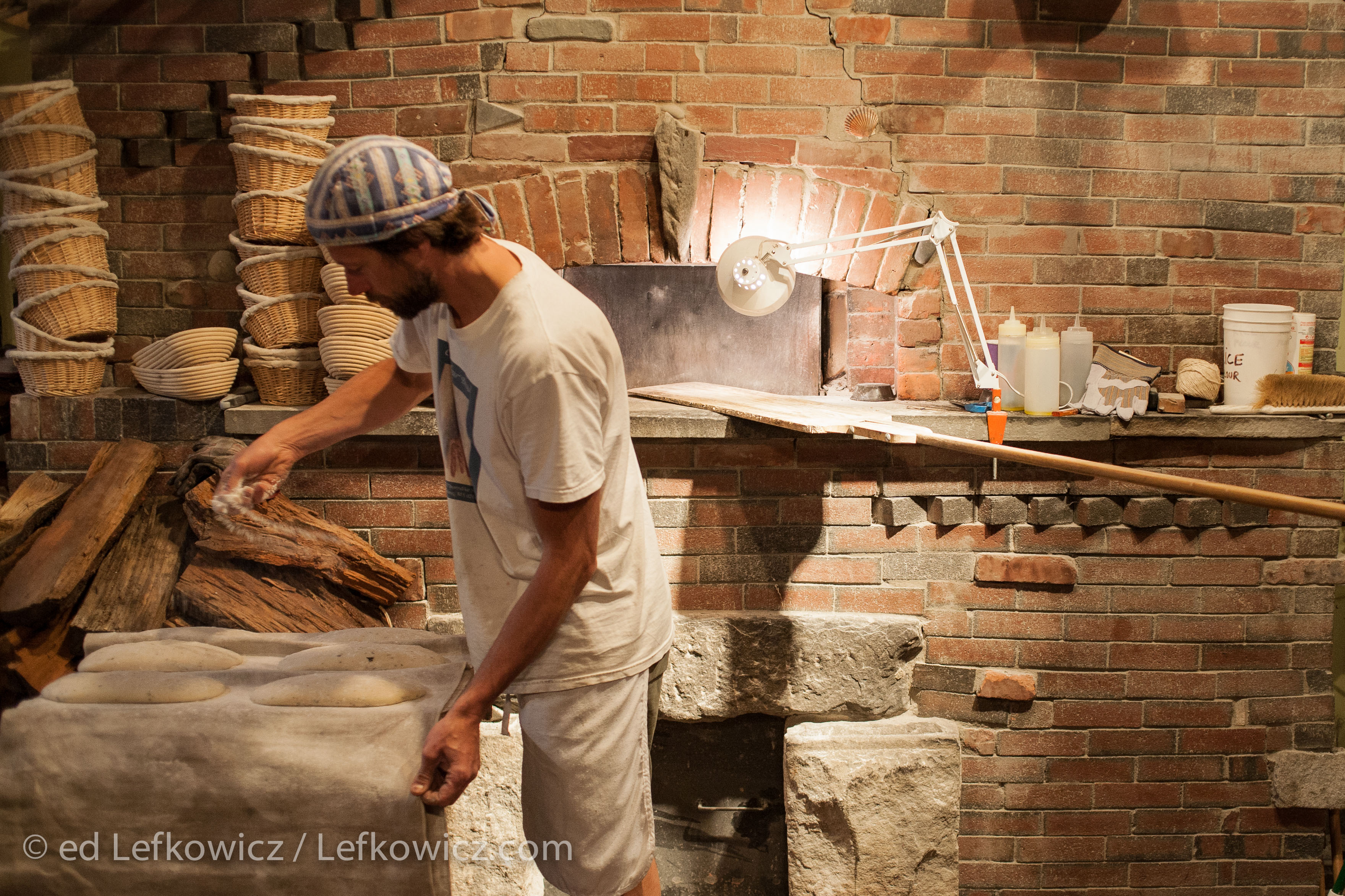 Andrea Colognese of The Village Hearth Bakery and Cafe, preparing loaves of bread for the oven. Colognese built the oven himself.