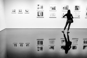 A woman looking at Sally Mann's photos of Cy Twombly's studio at Gagosian Gallery.