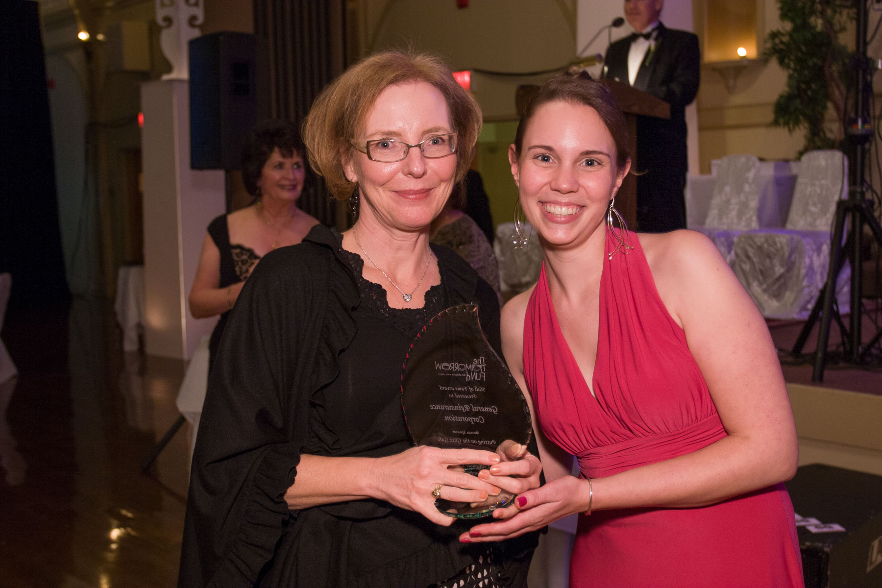 Two women with an award at a gala for the Tomorrow Fund for Children with Cancer