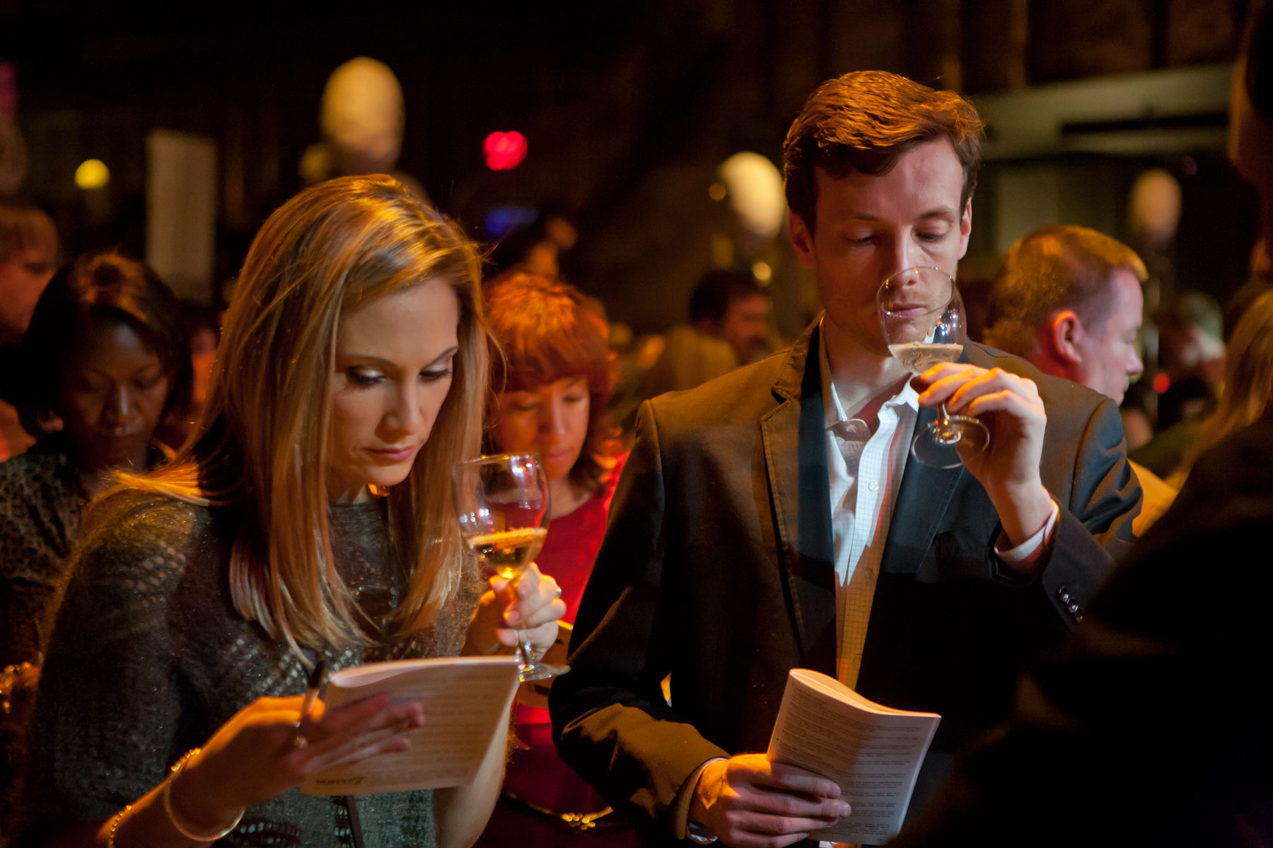A couple tasting wine and comparing notes at the New York Winter Wine Festival.