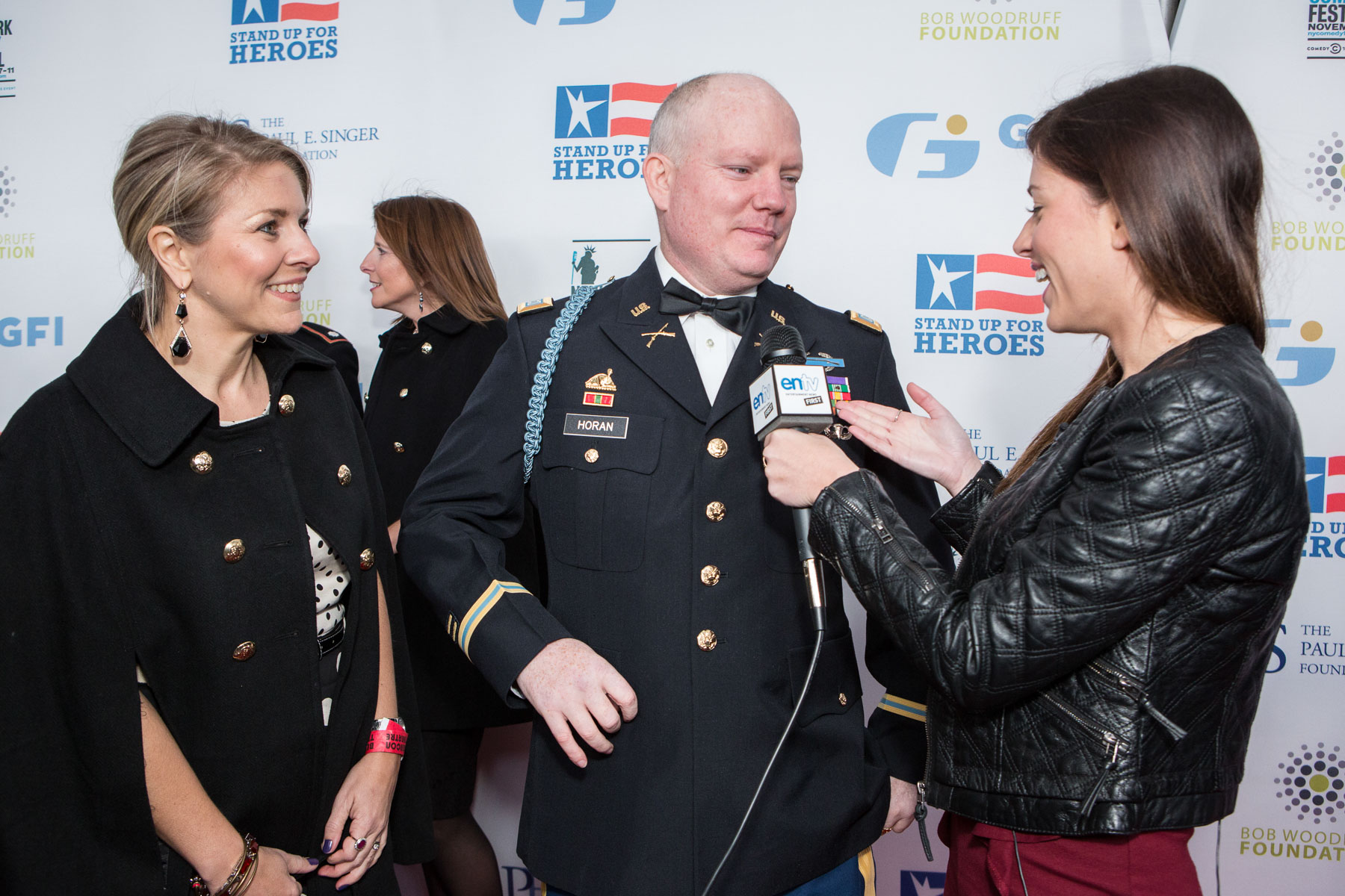 An army Captain being interviewed by a reporter at a Stand Up for Heroes event in New York