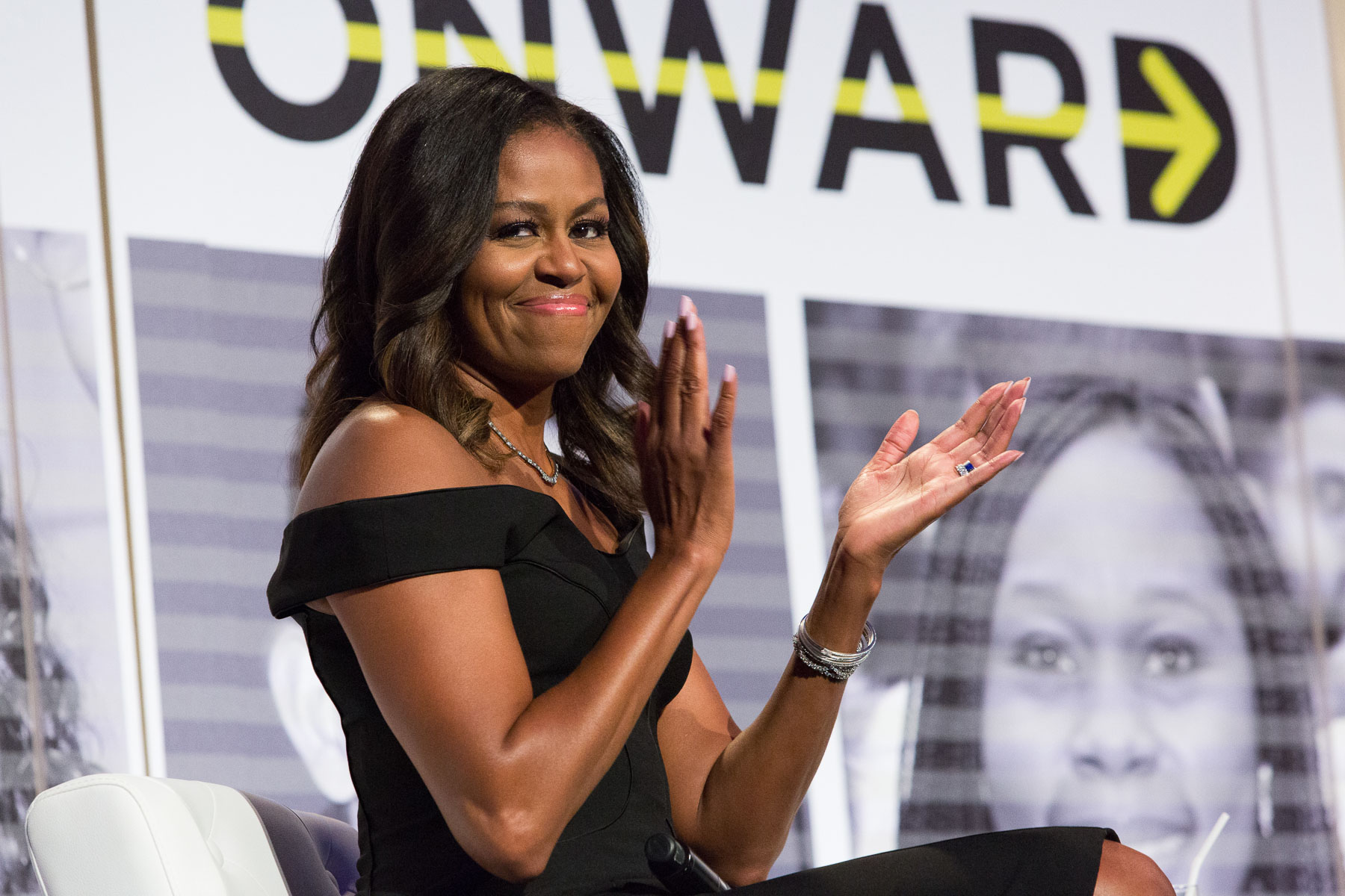Michelle Obama clapping at a gala for The Robert F. Toigo Foundation