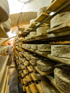 Cheeses ageing in the cellars of Crown Finish Caves.
