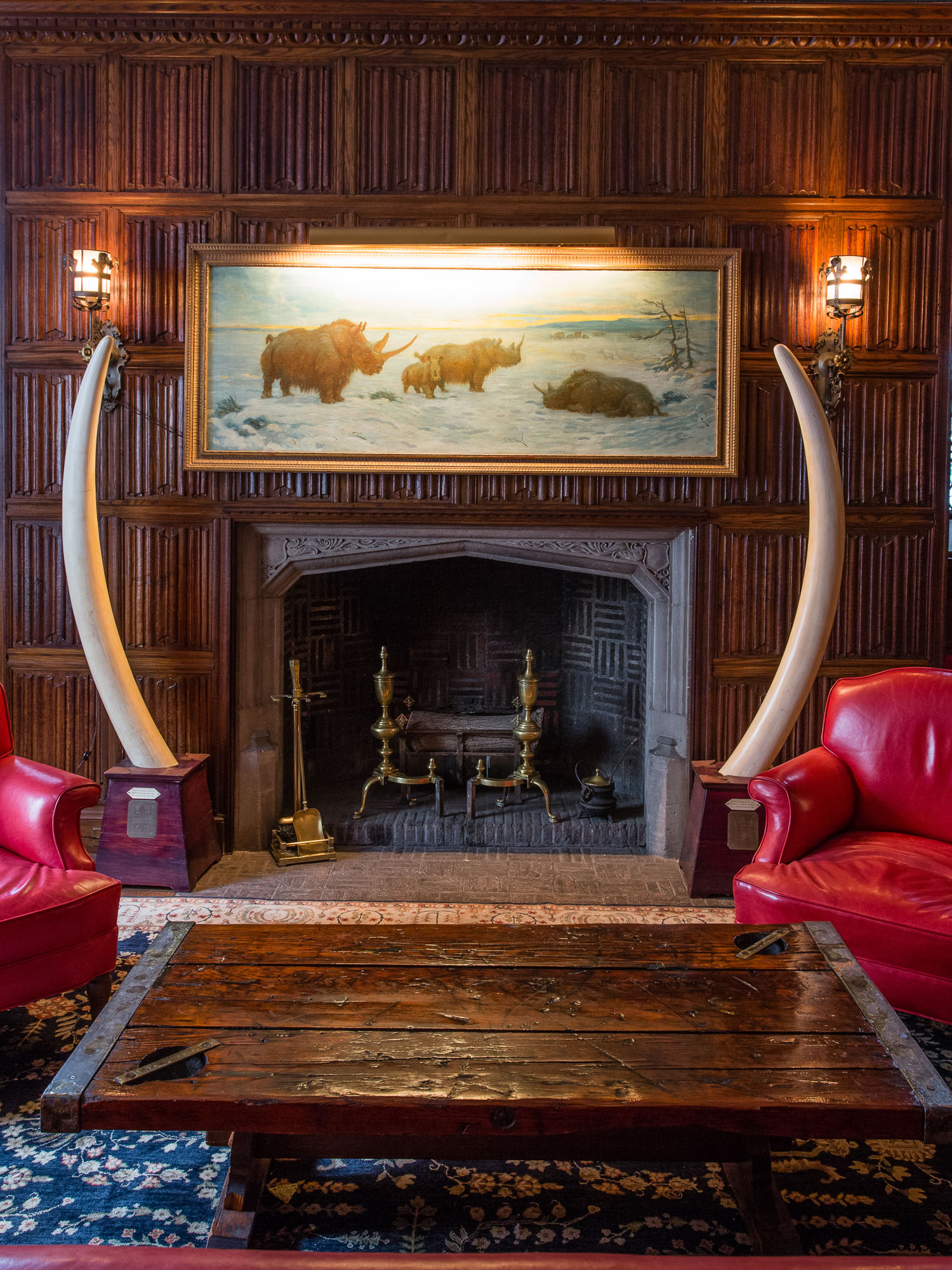 The fireplace in the members' lounge of The Explorers Club is flanked by two elephant tusks.