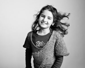 A girl tosses her hair energetically. Photographed for Flashes of Hope.