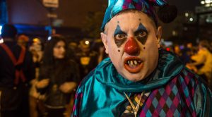 A man is costumed as a malevolent jester in the Greenwich Village Halloween Parade. 2013 is the 40th anniversary of the parade, which was cancelled in 2012 because of hurricane Sandy.