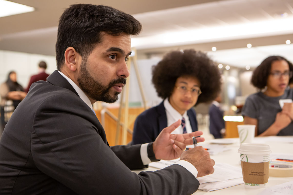Financial advisor working with high school students at a business skills competition, photographed for Morgan Stanley and the African American Men of Westchester.
