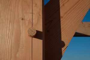 Construction site, post and beam framing closeup with pegged mortise and tenon joint