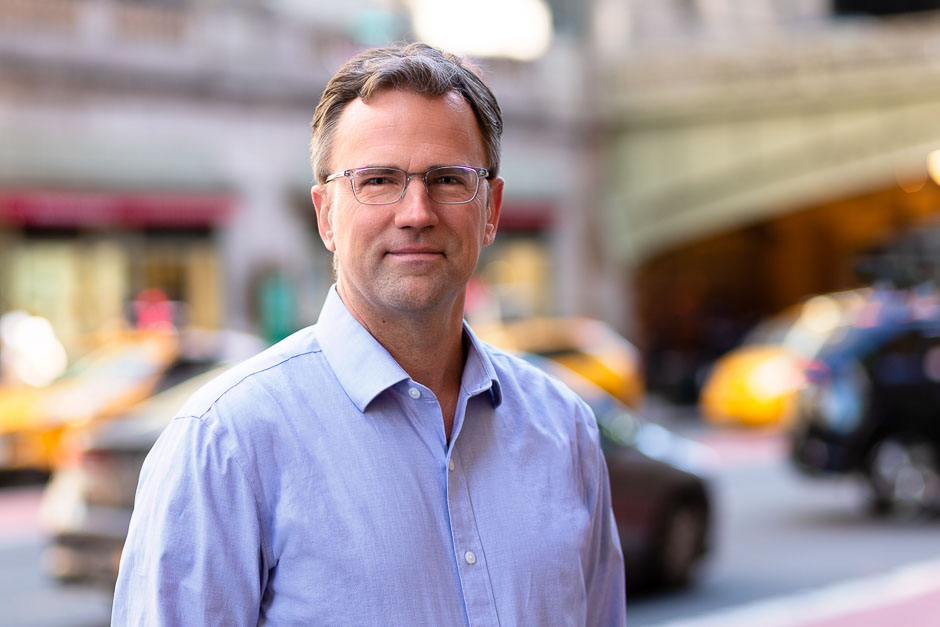 Branding photo of a consultant in New York City with Grand Central Terminal and traffic behind him
