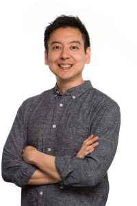 Portrait of a smiling Asian man with his arms crossed