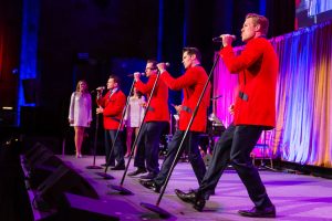 Jersey Boys in red jackets perform at a gala