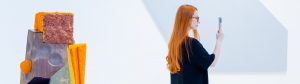 A woman amid art at an art fair