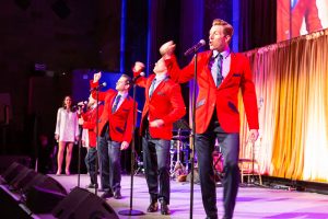 Photo of the Jersey boys in red jackets performing