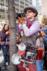 A photographer laden with cameras